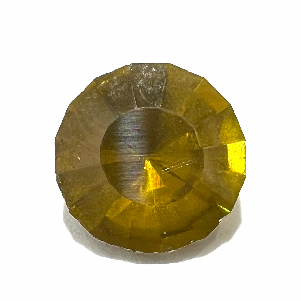 A loose, modified round brilliant cut sphalerite gemstone.