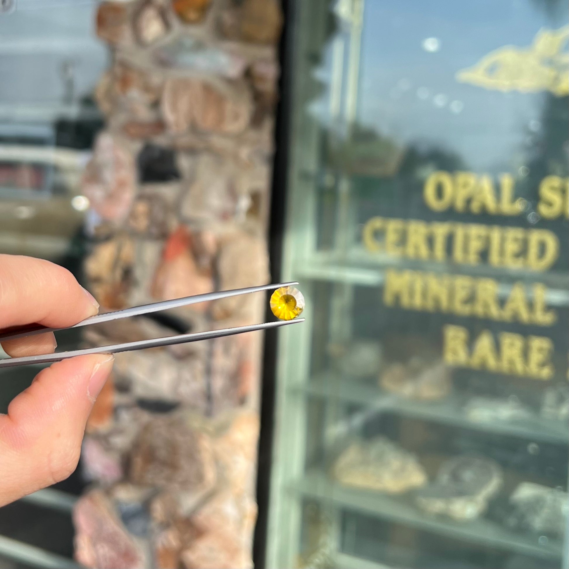 A loose, modified round brilliant cut sphalerite gemstone.