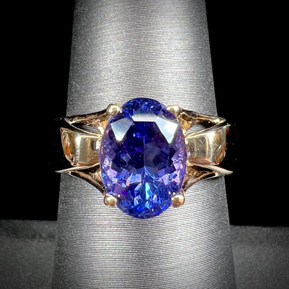 A ladies' oval cut tanzanite solitaire ring set in yellow gold.