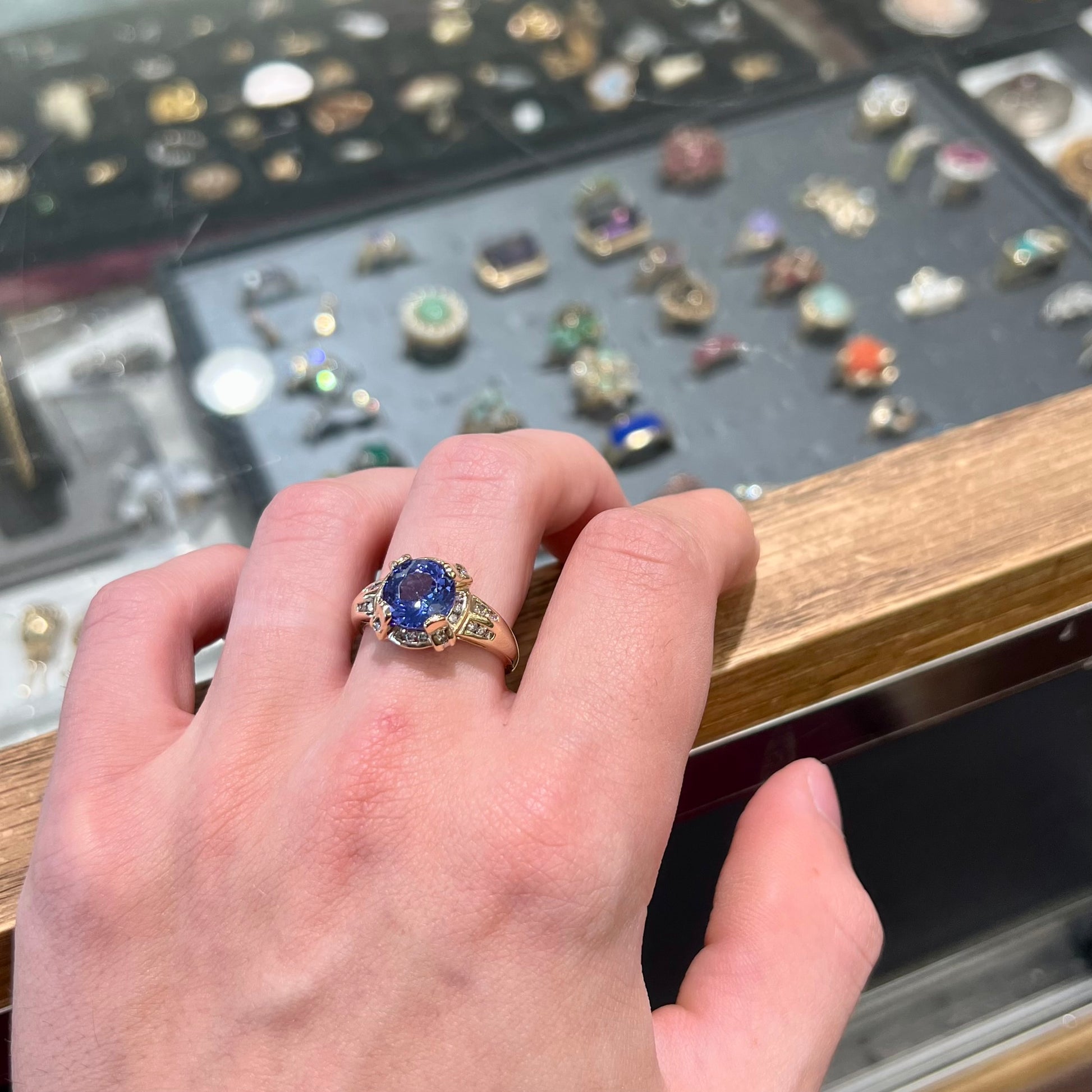 A ladies' yellow gold natural tanzanite and diamond ring.  Diamonds are channel set along the shank and in the prongs.