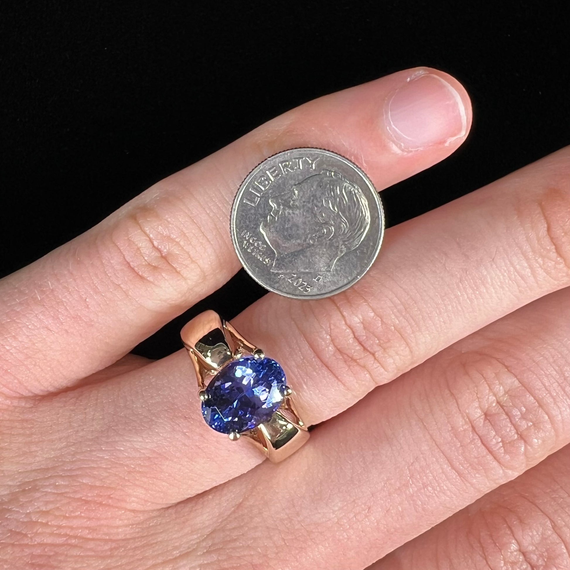 A ladies' oval cut tanzanite solitaire ring set in yellow gold.