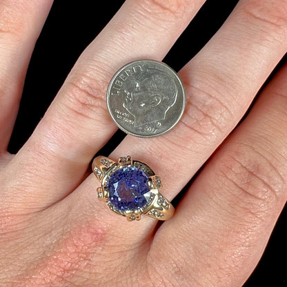 A ladies' yellow gold natural tanzanite and diamond ring.  Diamonds are channel set along the shank and in the prongs.