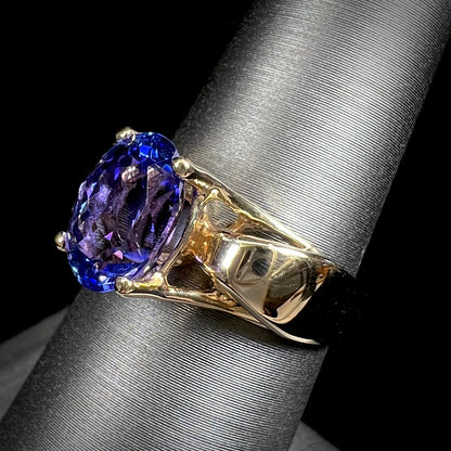 A ladies' oval cut tanzanite solitaire ring set in yellow gold.
