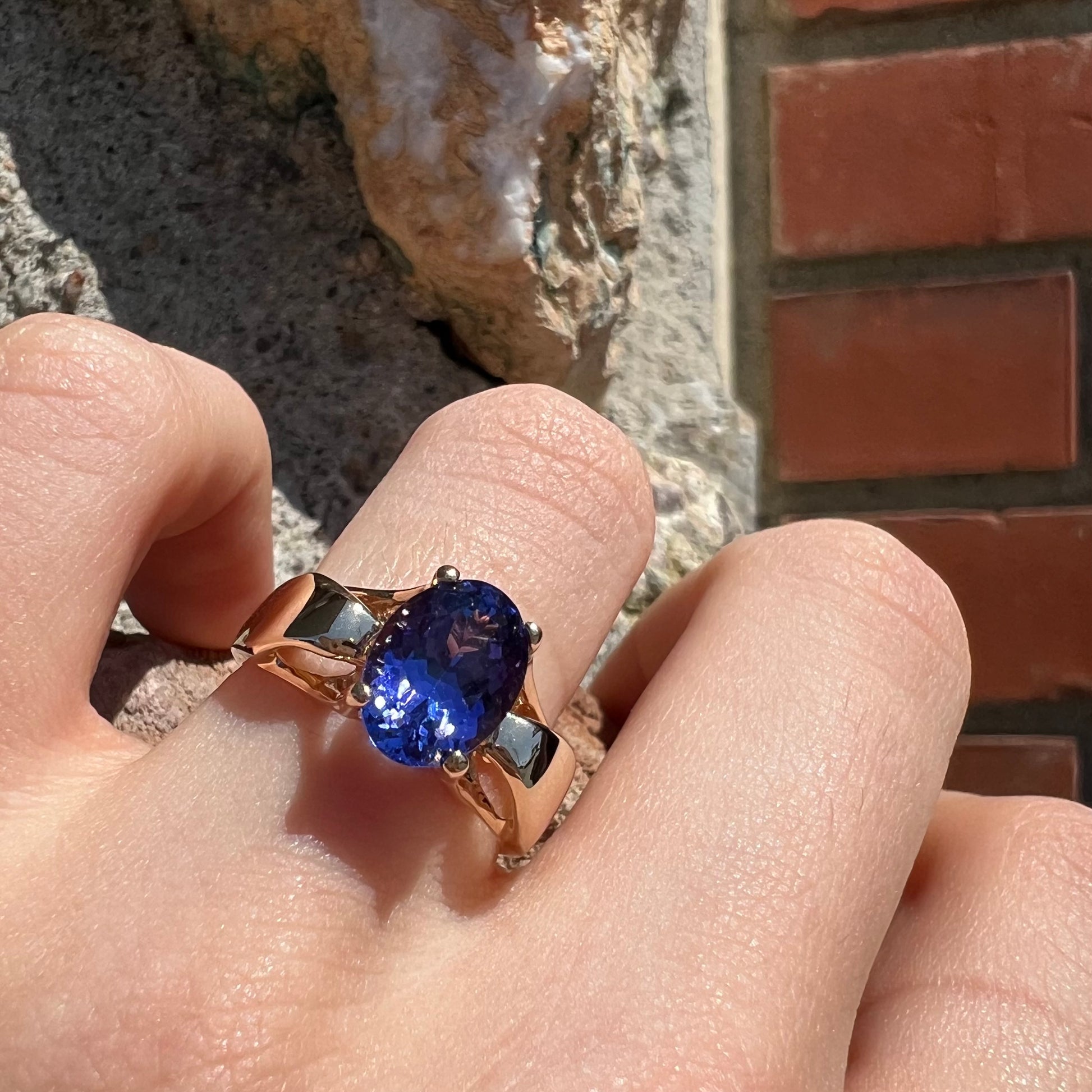 A ladies' oval cut tanzanite solitaire ring set in yellow gold.