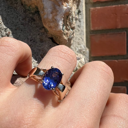 A ladies' oval cut tanzanite solitaire ring set in yellow gold.