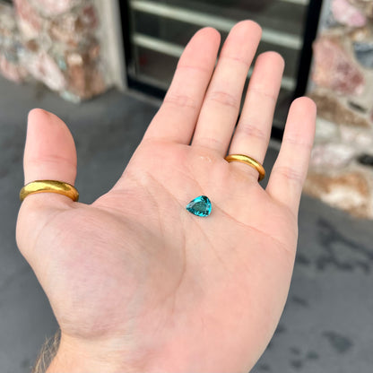 A loose, pear shaped green-blue indicolite tourmaline stone.