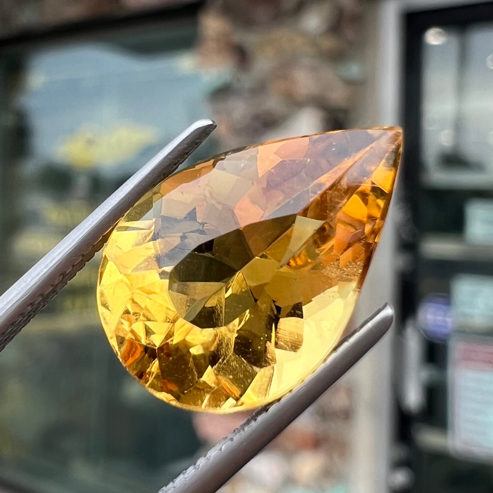 A loose, pear shaped golden beryl gemstone.