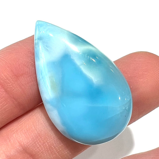 A loose, AAA+ grade, pear shaped cabochon cut blue larimar stone from Dominican Republic.