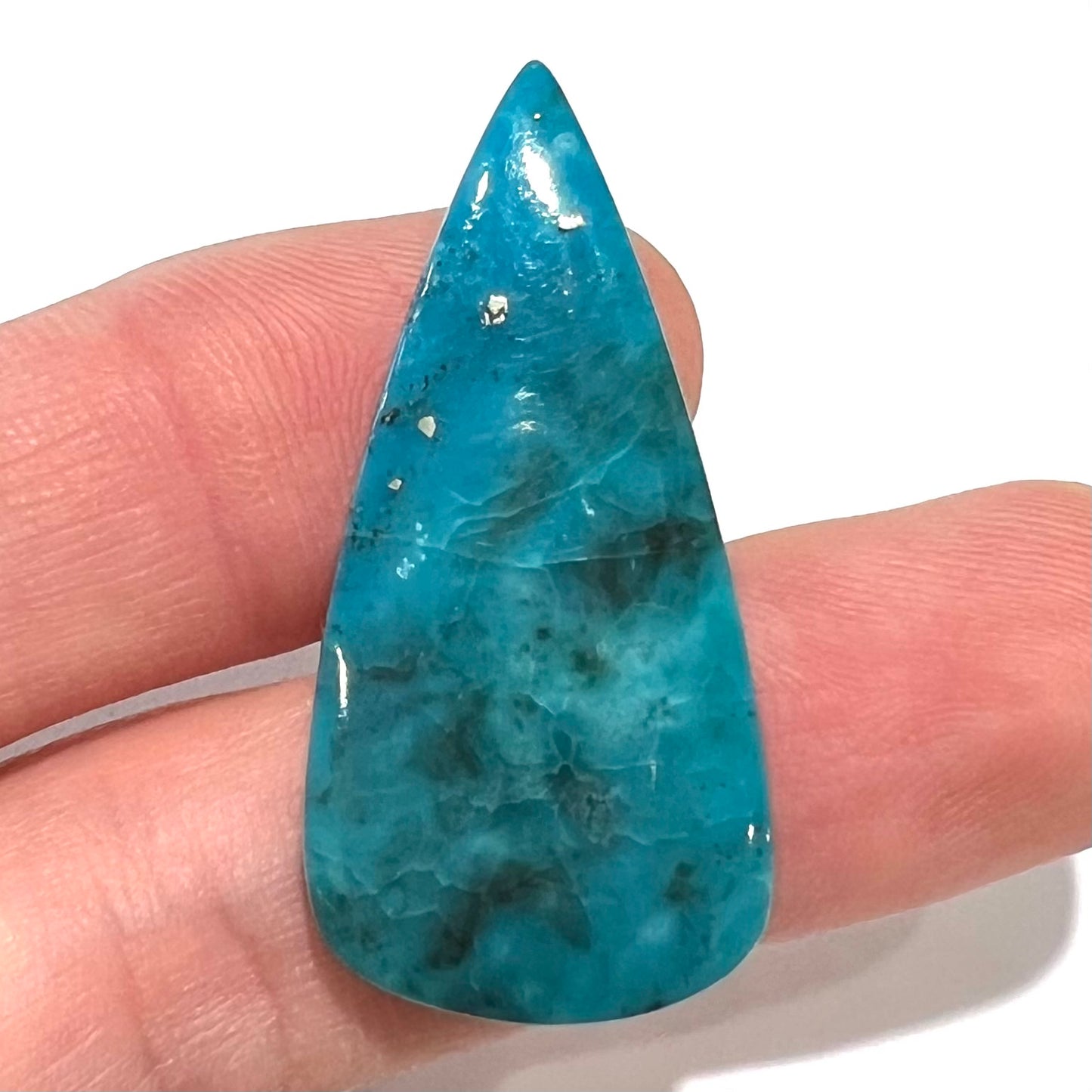 A loose, pear shaped turquoise stone from the Courtland-Gleeson mining district of Arizona.