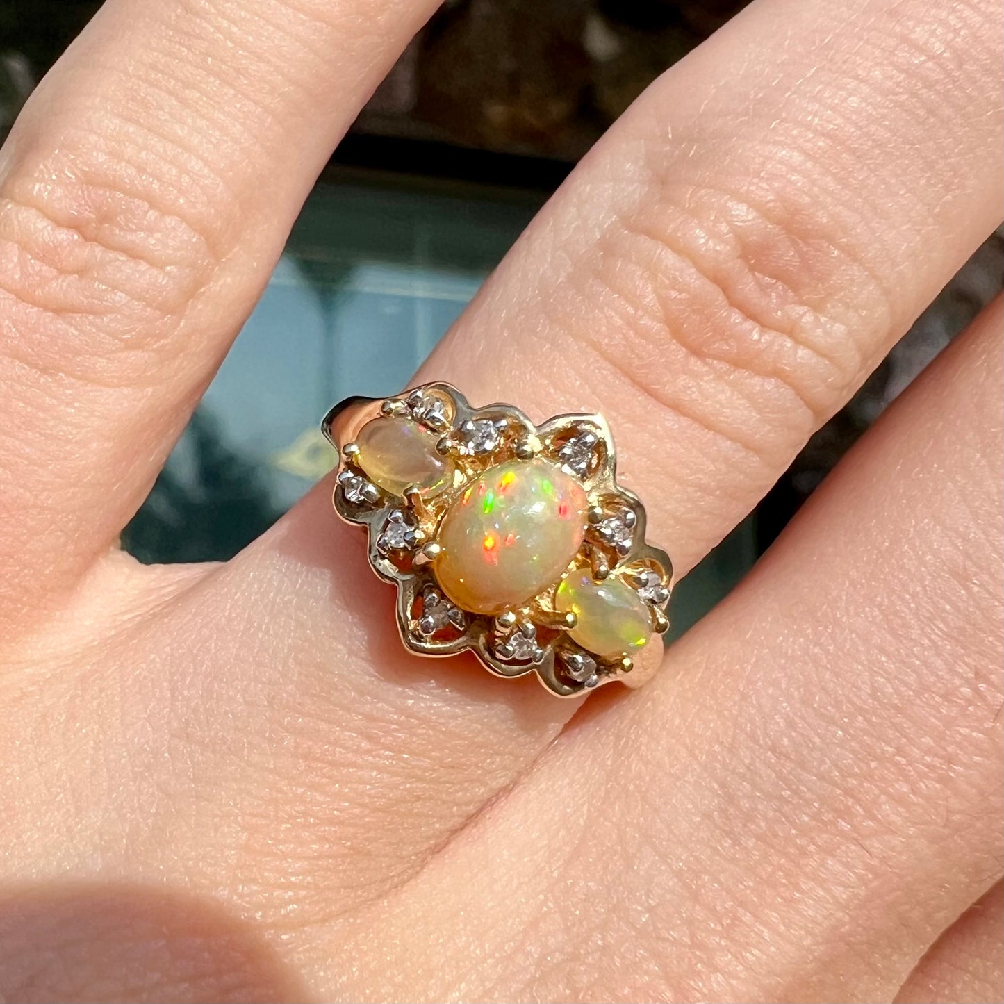 A three-stone gold ring set with Ethiopian fire opals and diamond accents.
