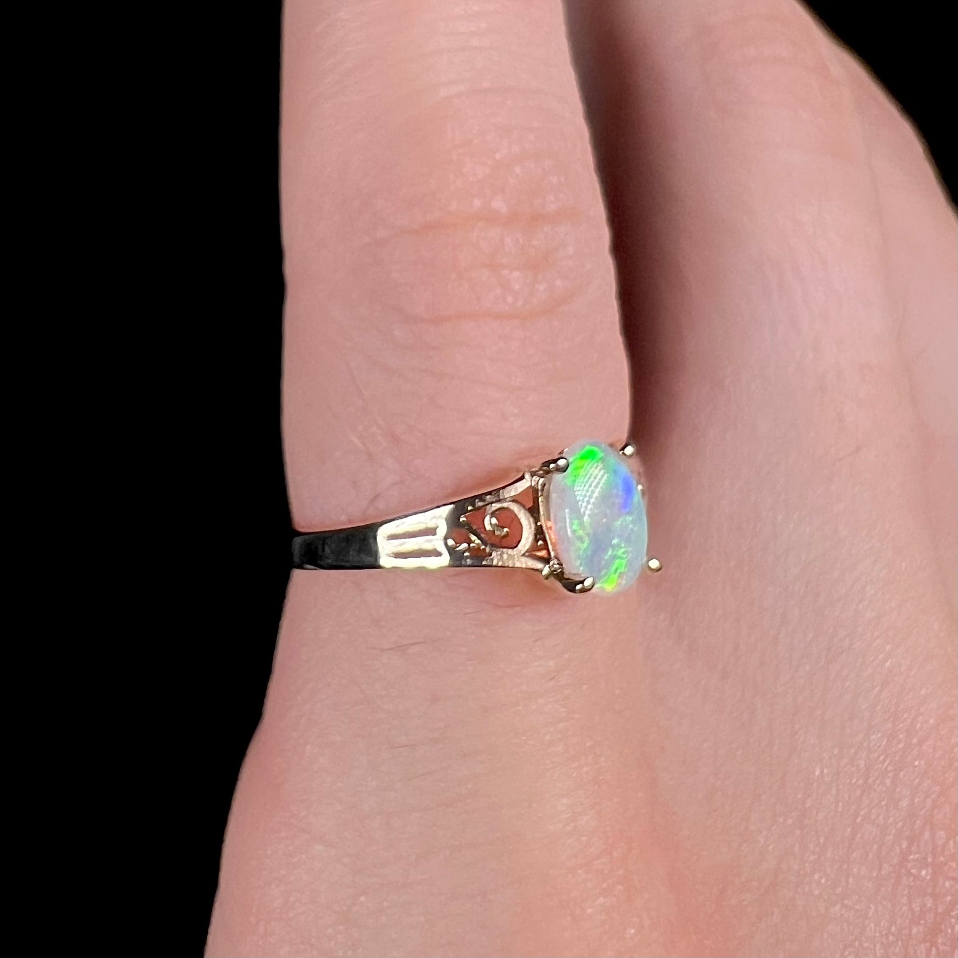 Ladies' 10 karat yellow gold opal solitaire ring.  The ring has filigree accents.