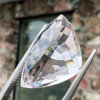 A loose, modified trillion cut kunzite gemstone.  The stone weighs 14.81 carats.