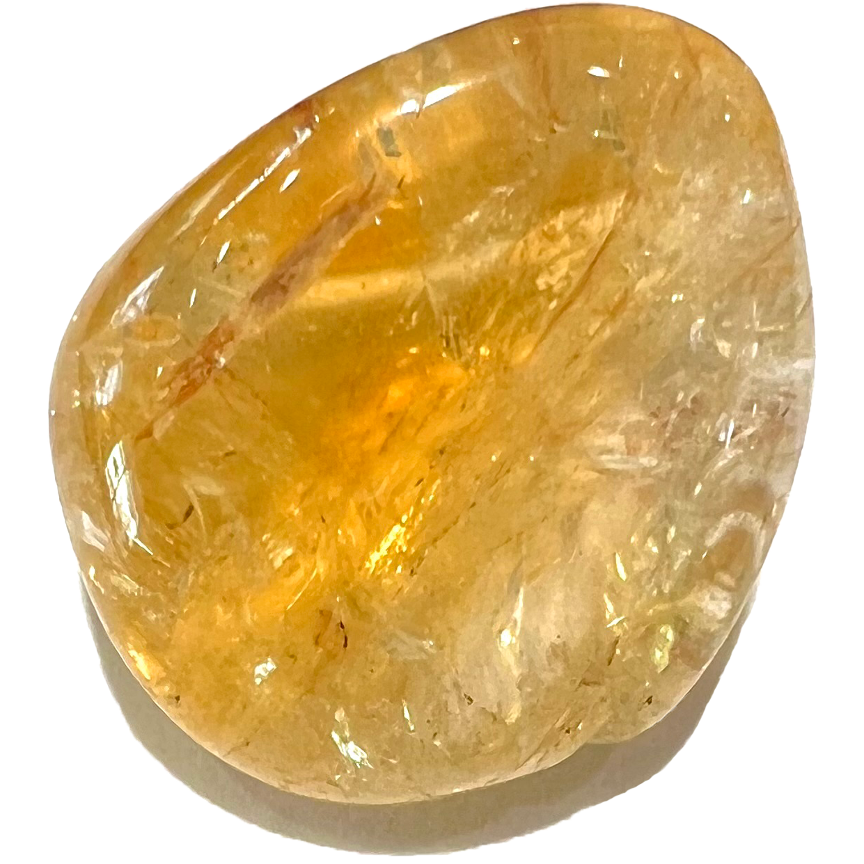 A transparent, yellow, tumbled citrine stone.