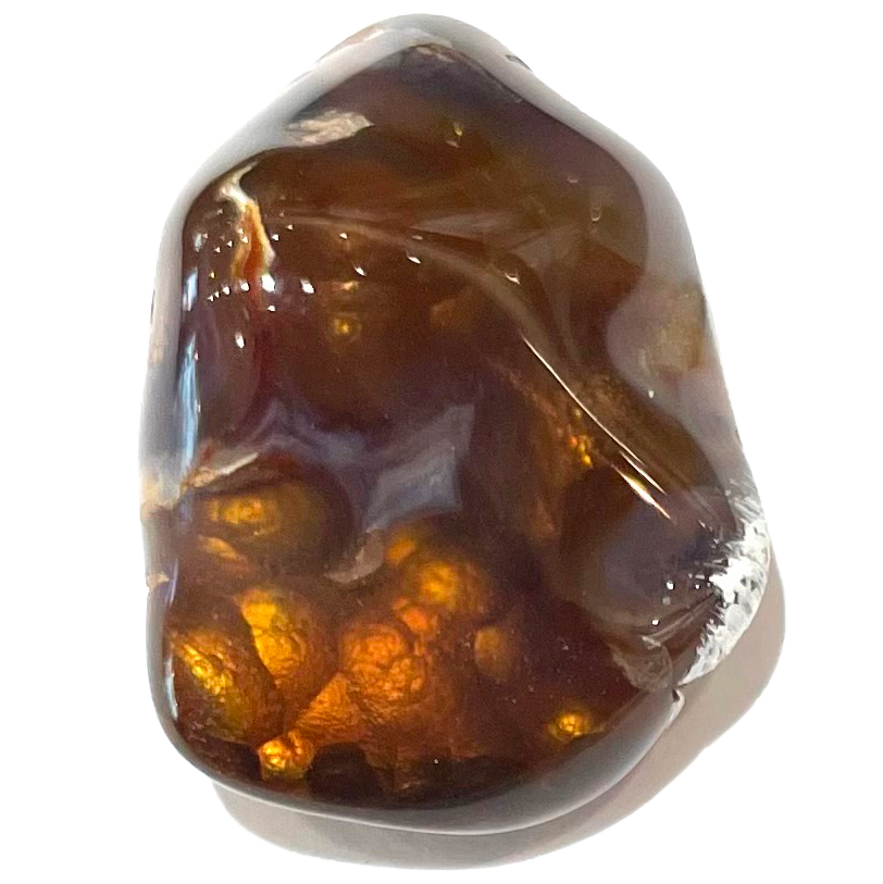 A tumbled Mexican fire agate stone.  The stone shows orange and yellow iridescence.