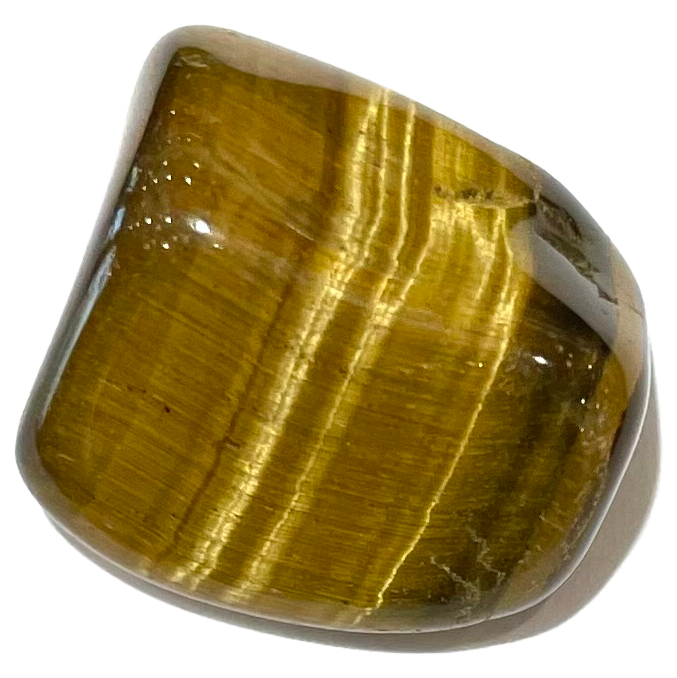 A tumbled golden tiger's eye stone.  Chatoyant light reflections are seen forming a cat's eye.