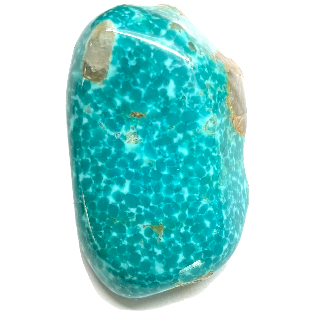 A tumbled turquoise stone.  The stone is spotted blue-green with white quartz inclusions.