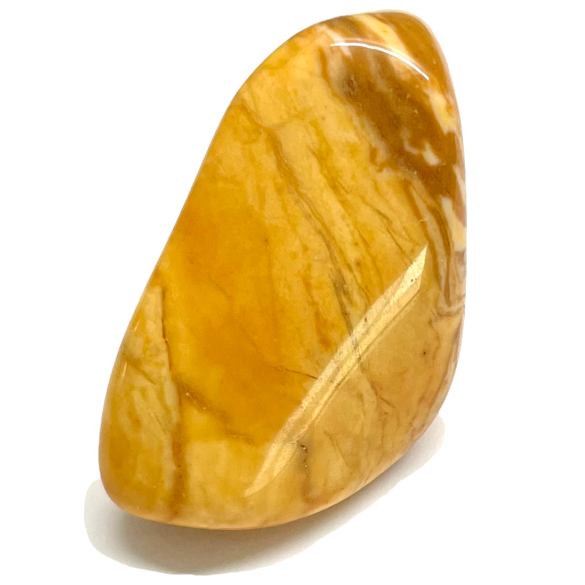 A tumbled yellow jasper stone.  Light and dark yellow colors are seen.