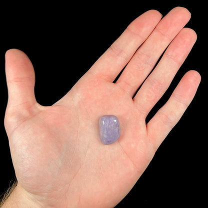 A tumbled Turkish purple jade stone, also known as turkiyenite.