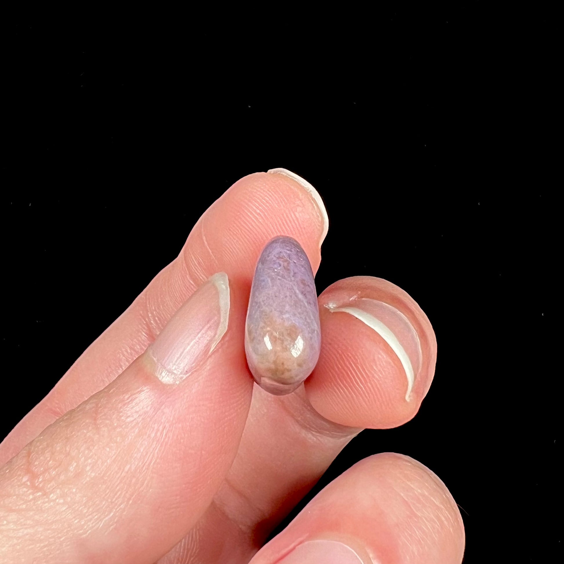 A tumble polished purple turkiyenite jade stone from Bursa, Turkey.