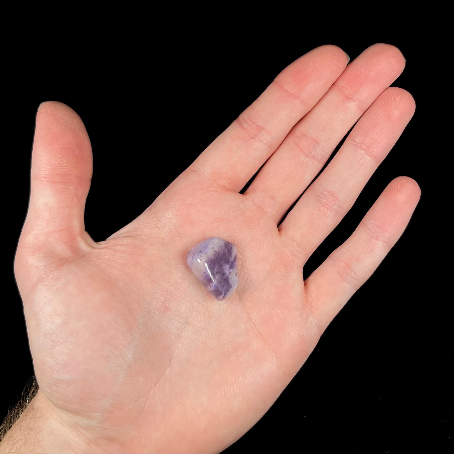 A streaked and spotted purple turkiyenite jade stone from Bursa, Turkey.