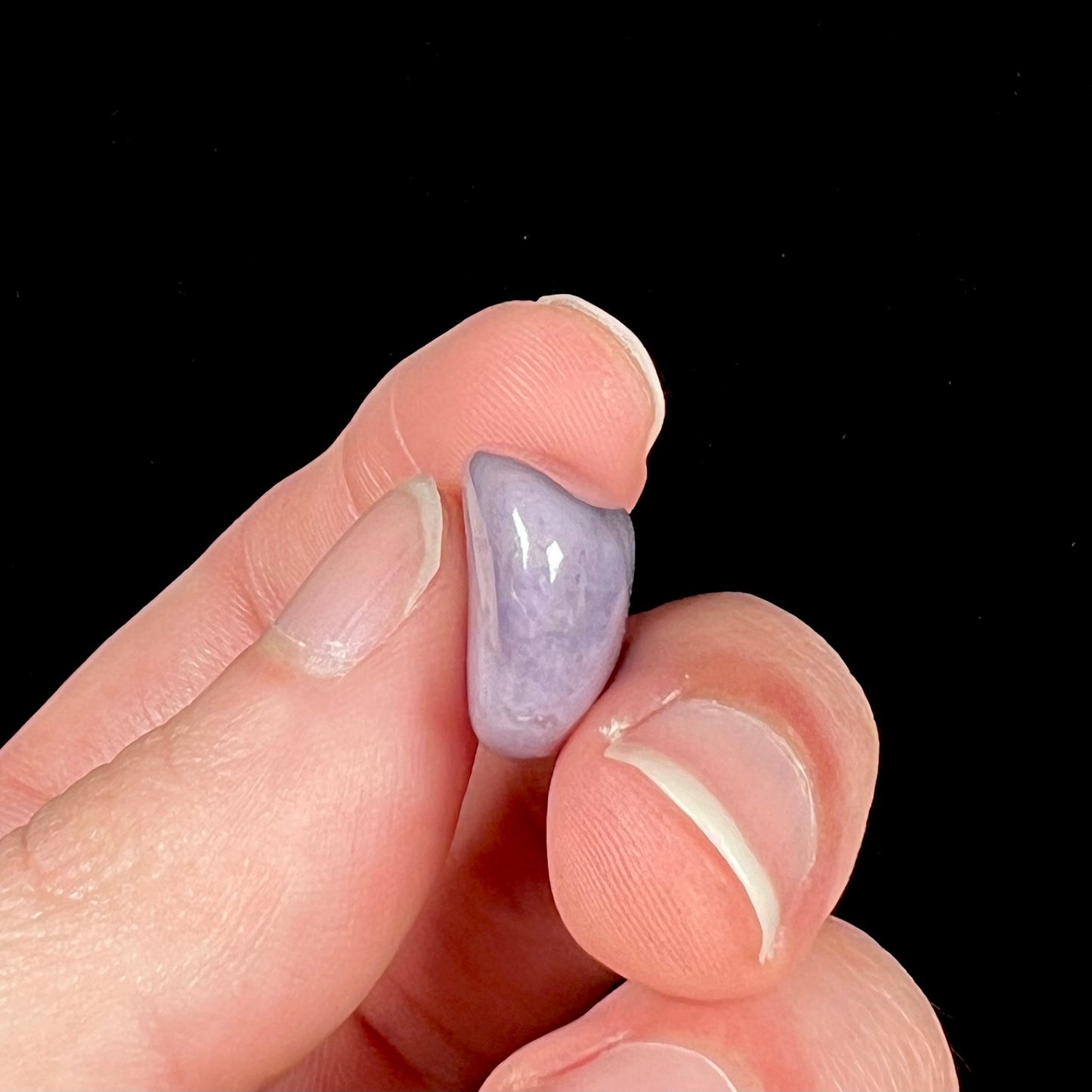 A tumbled Turkish purple jade stone, also known as turkiyenite.