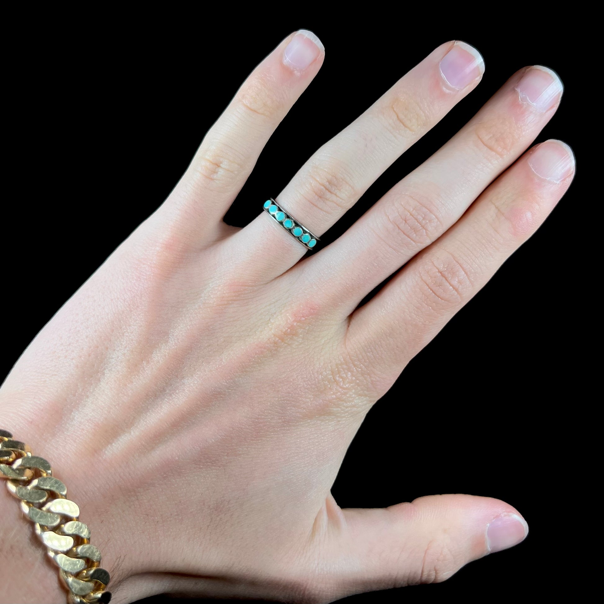 A ladies' sterling silver Hopi style band set with round cut Sleeping Beauty turquoise stones.