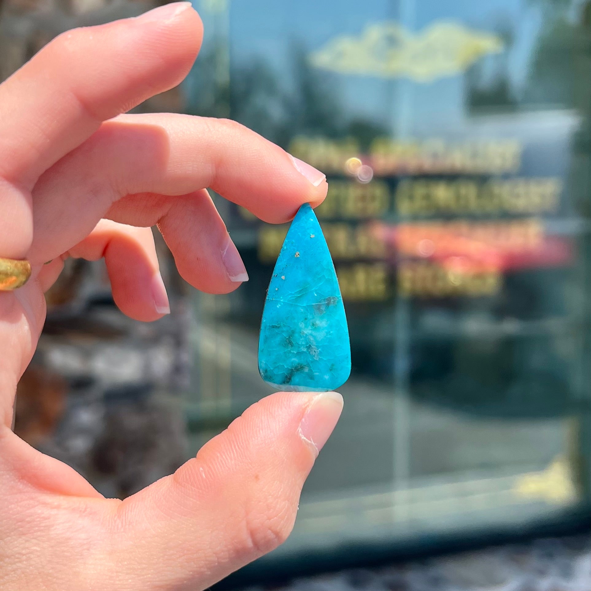 A loose, pear shaped turquoise stone from the Courtland-Gleeson mining district of Arizona.
