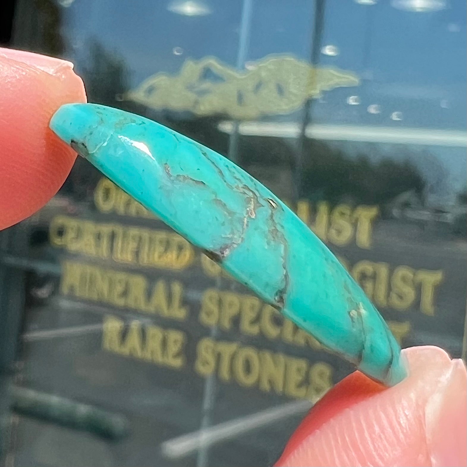 A loose, oval cabochon cut turquoise stone from Royston District, Nevada.
