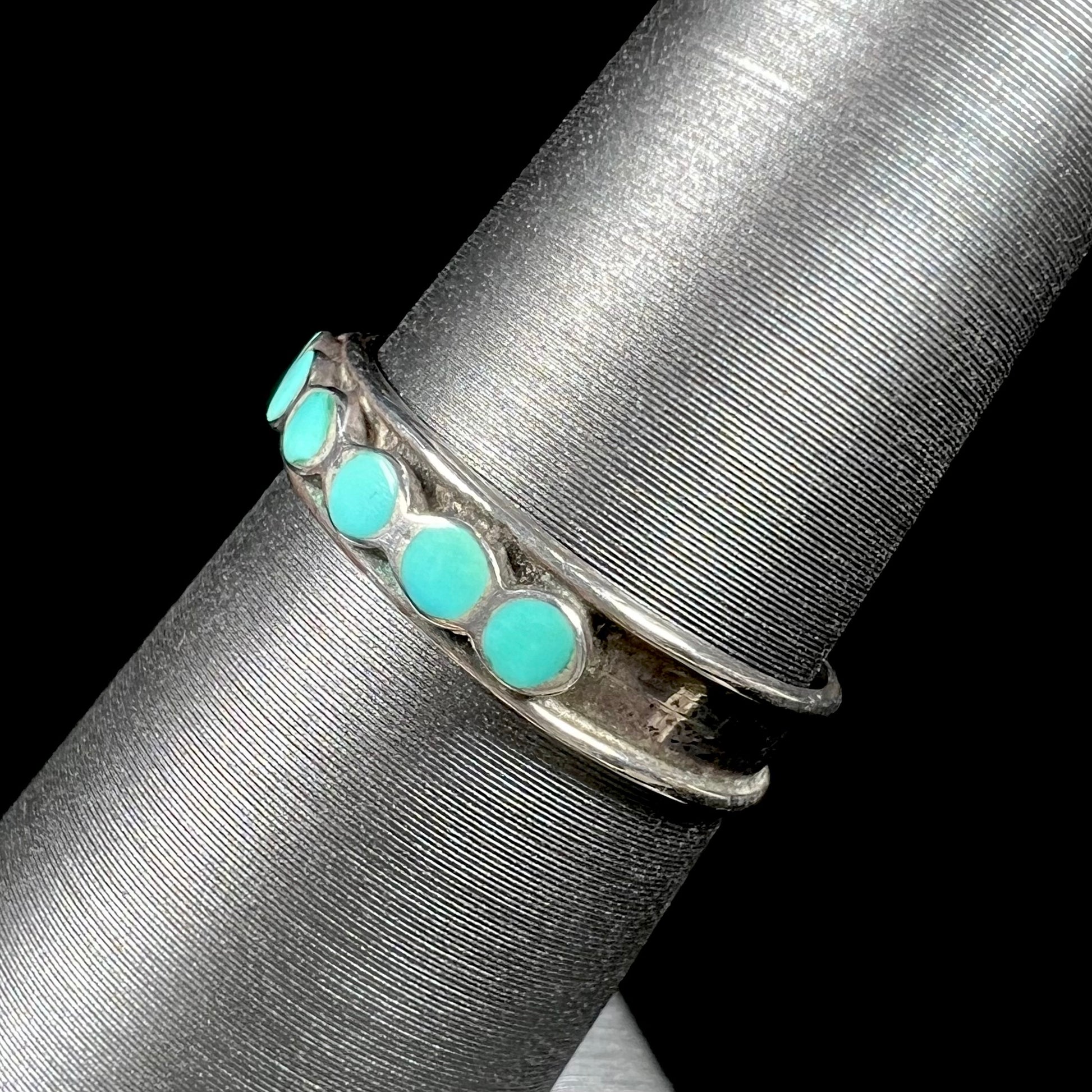 A ladies' sterling silver Hopi style band set with round cut Sleeping Beauty turquoise stones.