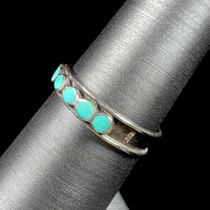 A ladies' sterling silver Hopi style band set with round cut Sleeping Beauty turquoise stones.