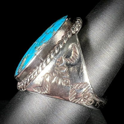 A men's sterling silver Morenci turquoise solitaire ring.  The ring has a Southwest Navajo style stamp pattern.