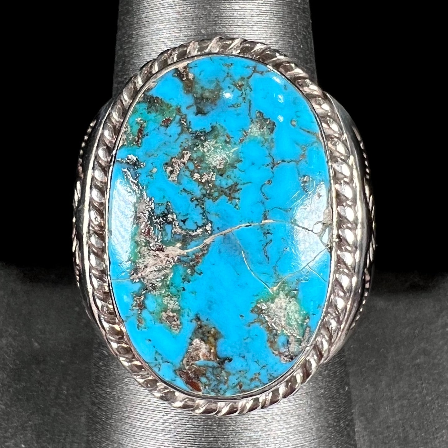 A men's sterling silver Morenci turquoise solitaire ring.  The ring has a Southwest Navajo style stamp pattern.