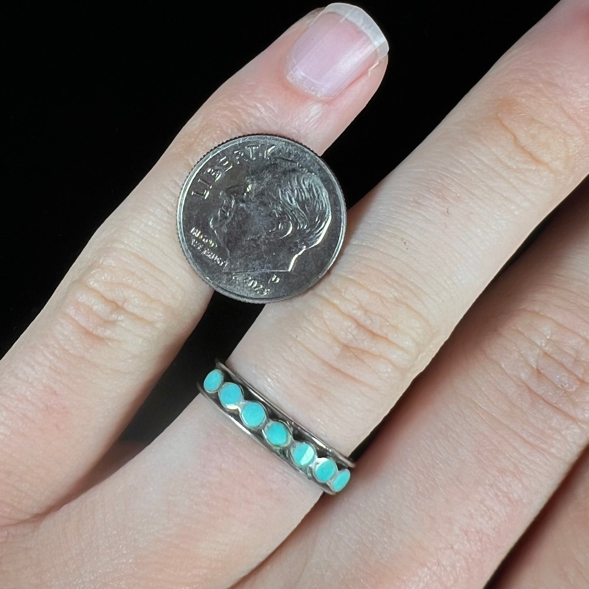 A ladies' sterling silver Hopi style band set with round cut Sleeping Beauty turquoise stones.