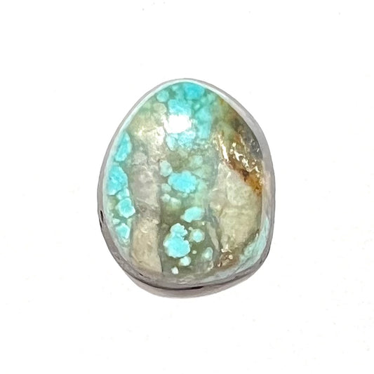 A loose, freeform pear shaped cabochon cut Valley Blue turquoise stone from Lander County, Nevada.  The stone is blue and green with quartz inclusions.