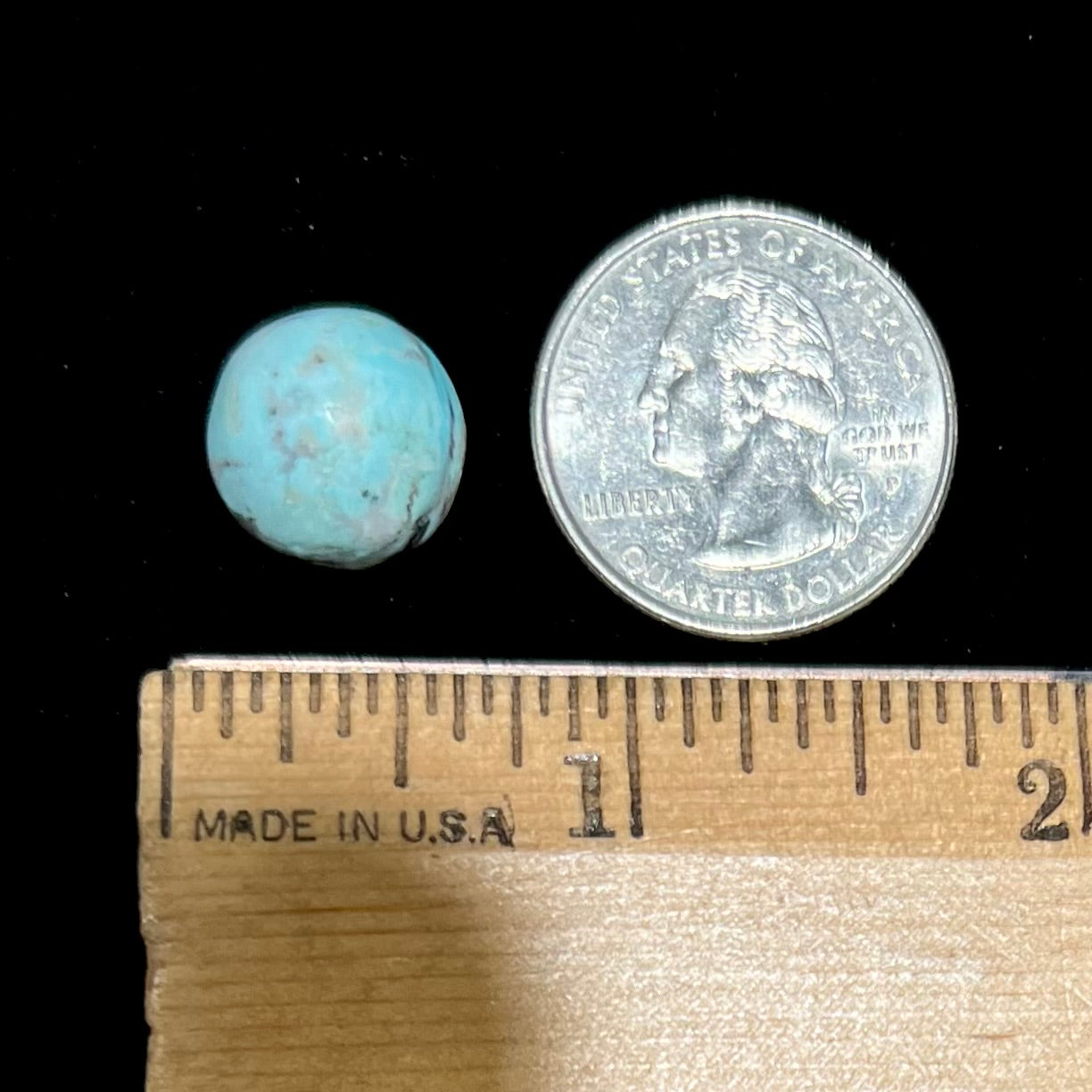 A loose, round cabochon cut Valley Blue turquoise stone.