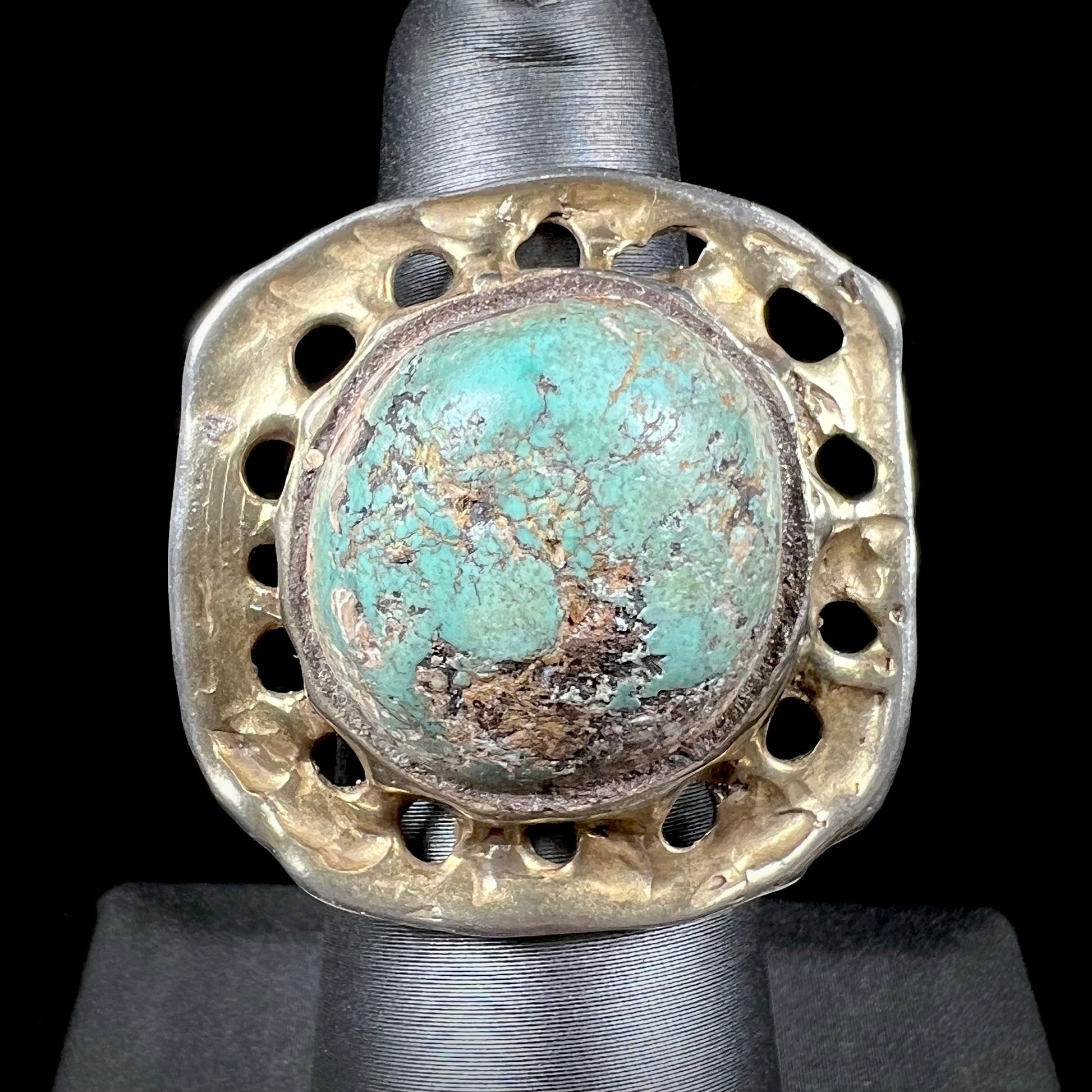 A unisex sterling silver ring with a gold wash, set with a natural, unstabilized Valley Blue turquoise stone.