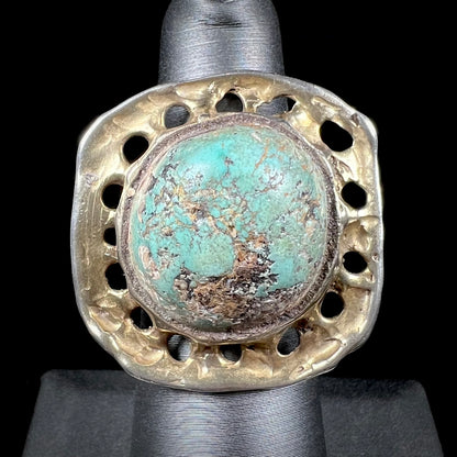 A unisex sterling silver ring with a gold wash, set with a natural, unstabilized Valley Blue turquoise stone.