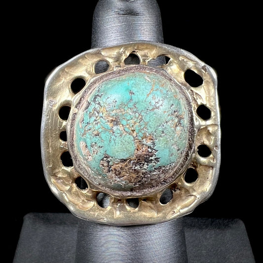 A unisex sterling silver ring with a gold wash, set with a natural, unstabilized Valley Blue turquoise stone.