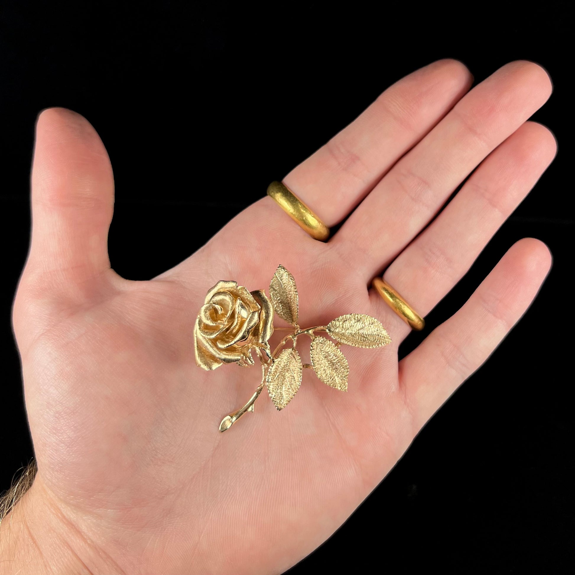 A vintage 14 karat yellow gold rose brooch.