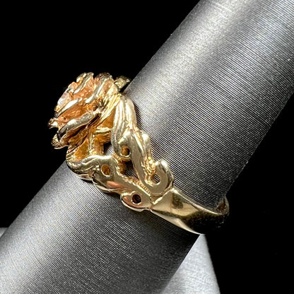 A ladies' yellow gold rose style ring set with a natural 0.10ct diamond.