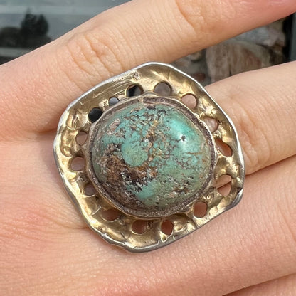 A unisex sterling silver ring with a gold wash, set with a natural, unstabilized Valley Blue turquoise stone.