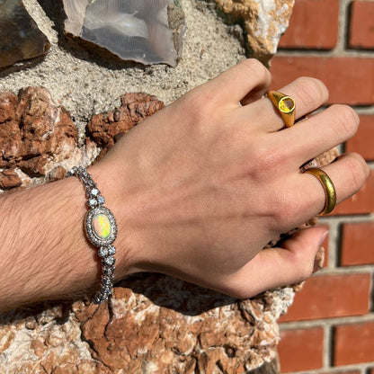 A ladies' vintage, 1930's natural opal bracelet set with accent diamonds in white gold.