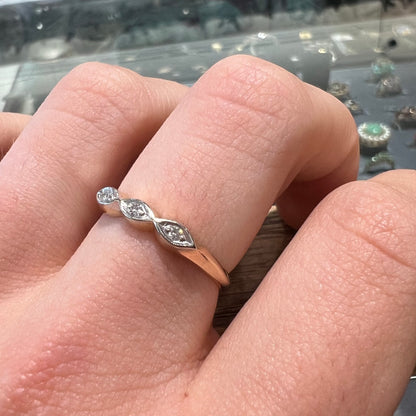 A vintage, yellow gold ladies' wedding band set with three single cut diamonds in marquise shaped designs.