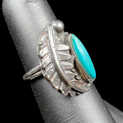 A ladies' sterling silver feather style ring set with a marquise cut turquoise stone.
