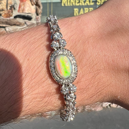 A ladies' vintage, 1930's natural opal bracelet set with accent diamonds in white gold.