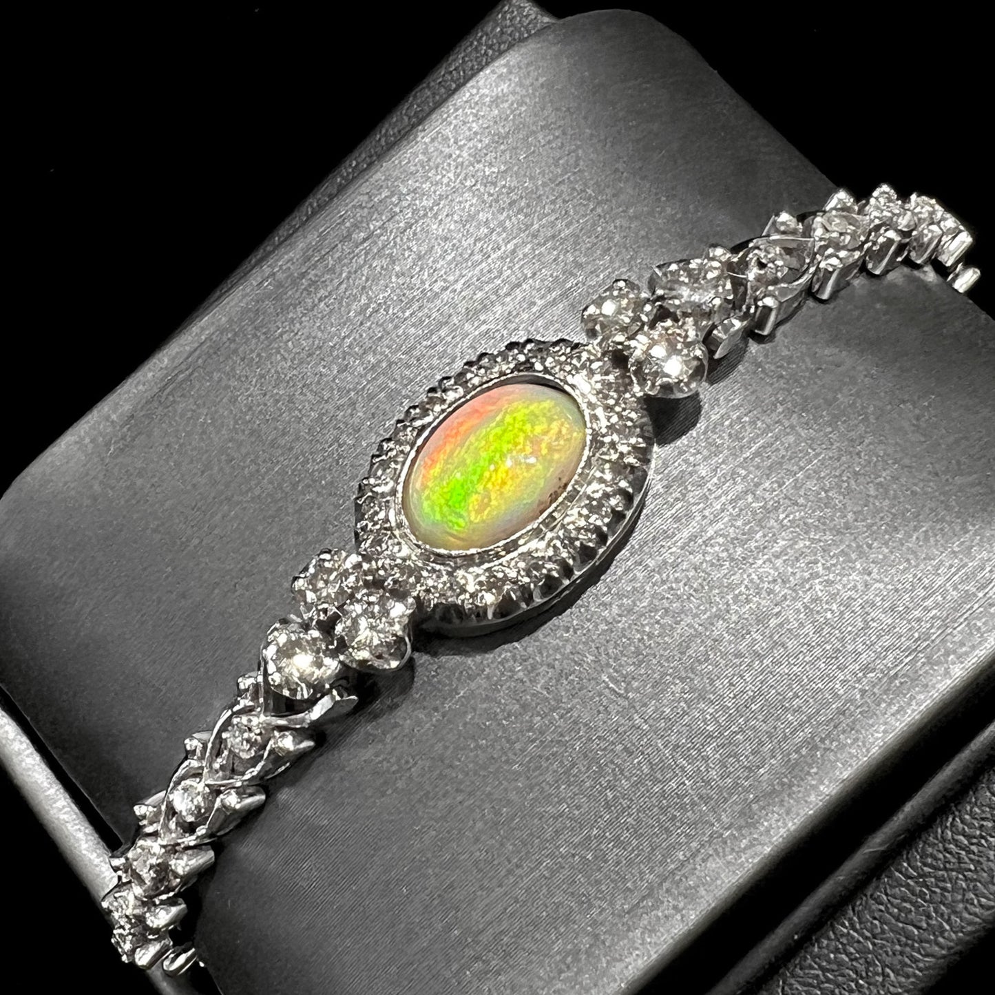 A ladies' vintage, 1930's natural opal bracelet set with accent diamonds in white gold.