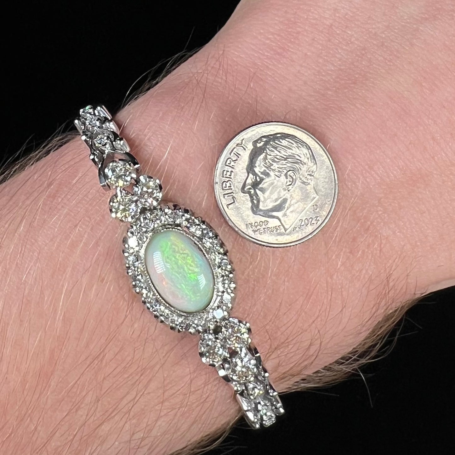 A ladies' vintage, 1930's natural opal bracelet set with accent diamonds in white gold.