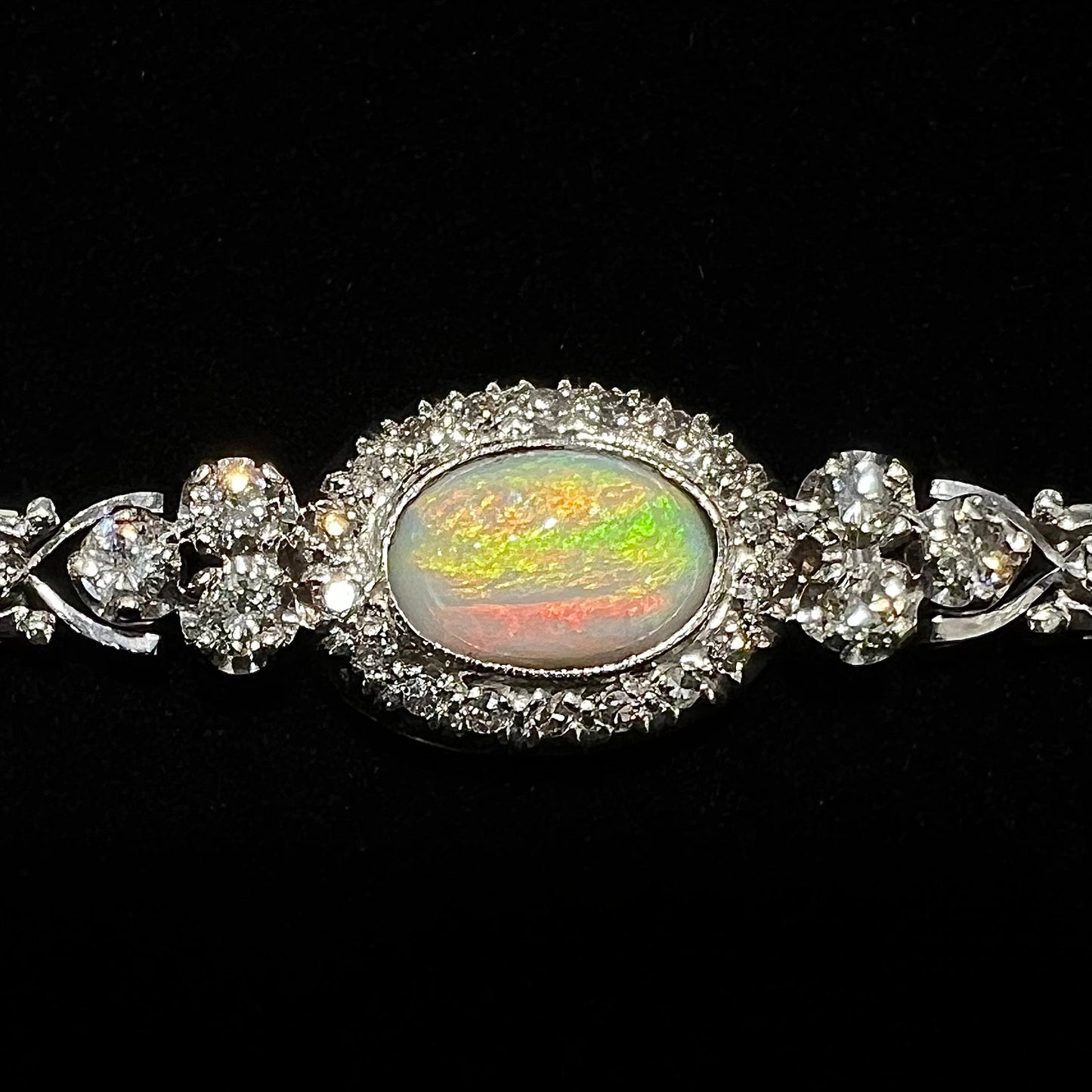 A ladies' vintage, 1930's natural opal bracelet set with accent diamonds in white gold.