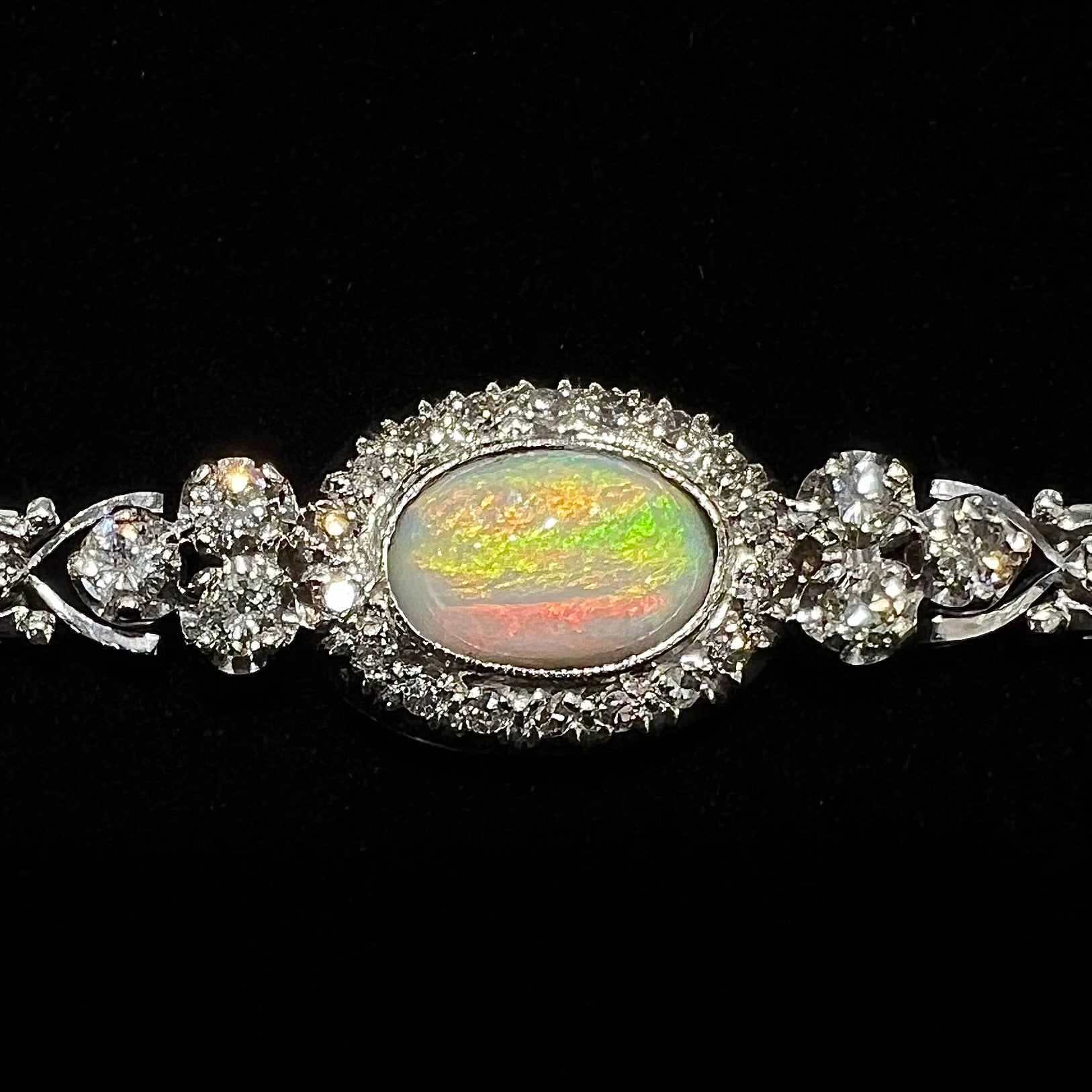 A ladies' vintage, 1930's natural opal bracelet set with accent diamonds in white gold.