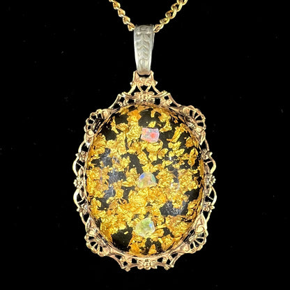 A vintage gold filled filigree necklace set with three rough opal crystals and gold leaf flakes.